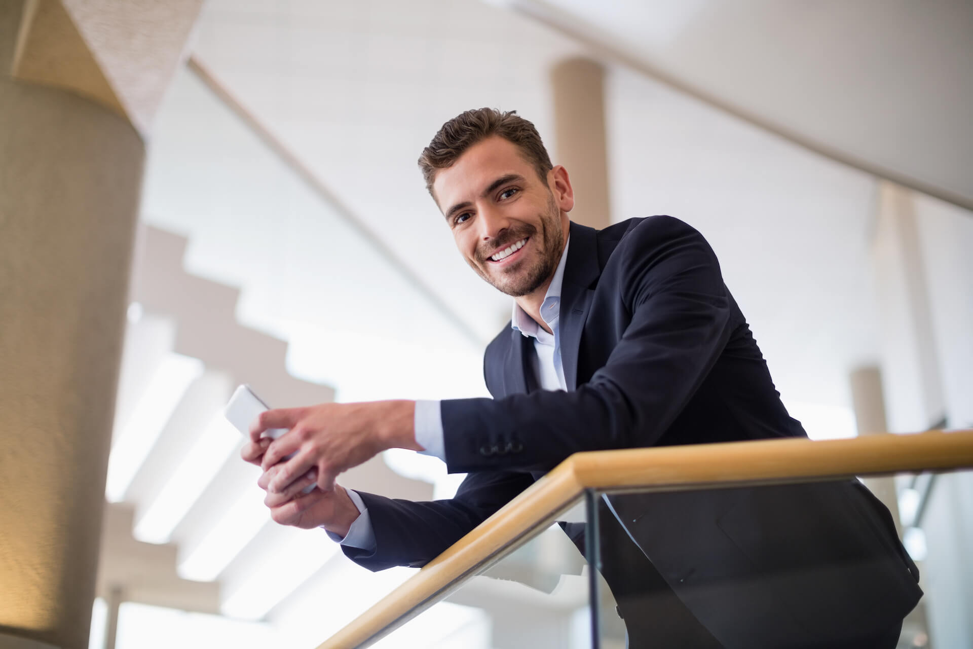 businessman-holding-mobile-phone-2021-08-28-18-10-37-utc.jpg