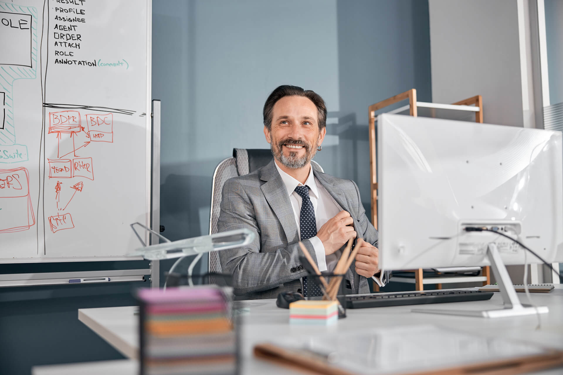 cheerful-businessman-in-gray-suit-working-in-moder-2021-09-03-14-19-38-utc.jpg