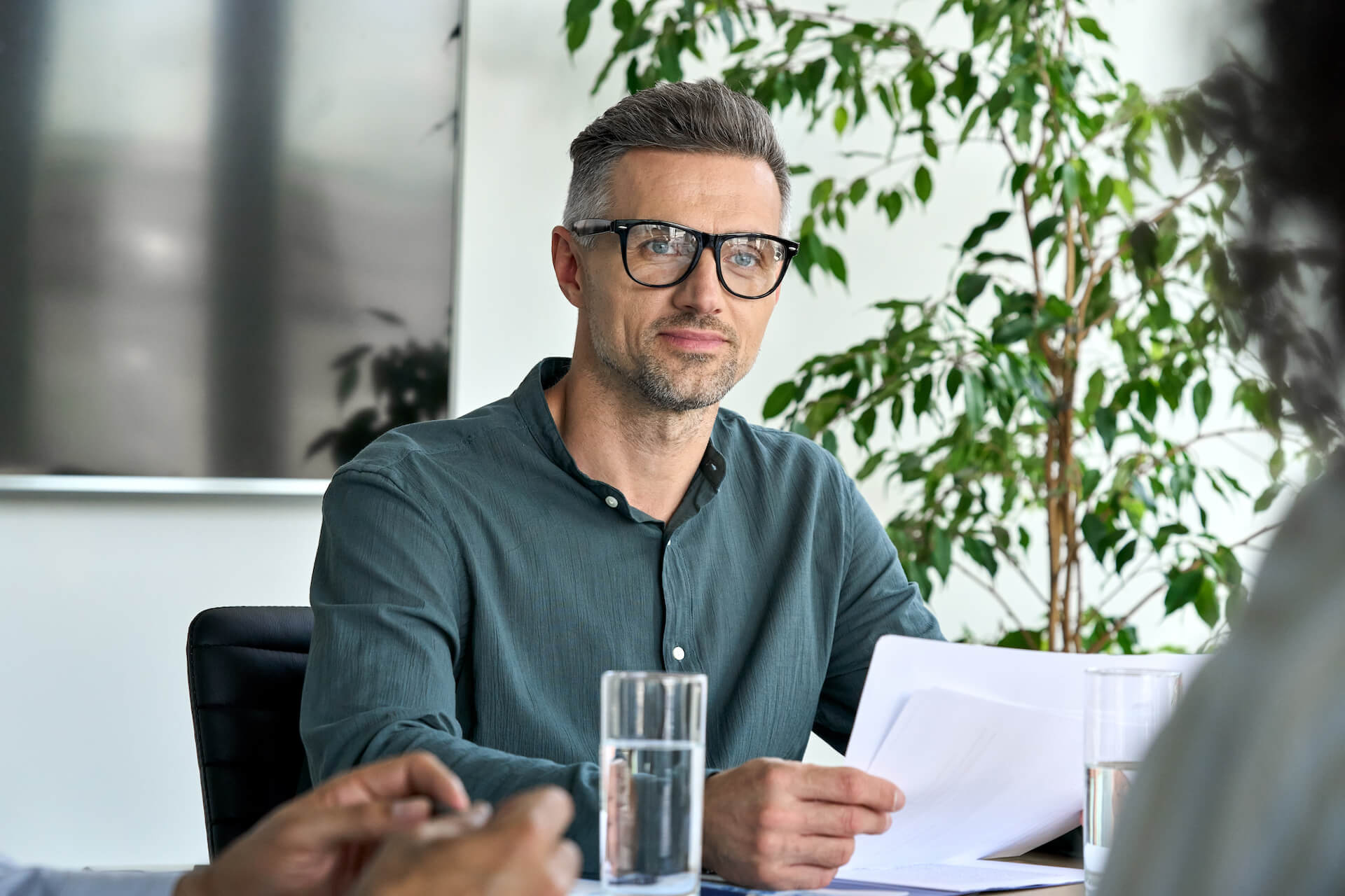 mature-male-ceo-listening-colleague-holding-papers-2021-09-04-09-42-09-utc.jpg